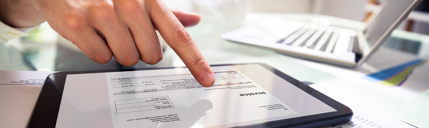 Businessperson Analyzing Invoice on Digital Tablet