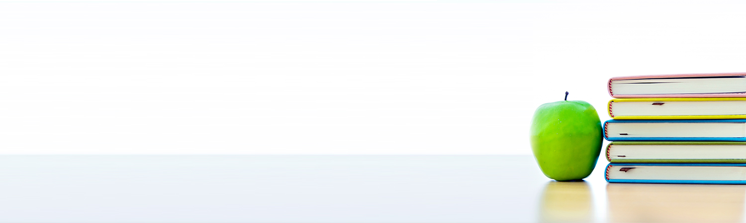 Stack of Books and Apple on Flat Surface